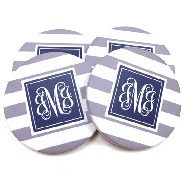 set of 4 gray stripe coasters with blue circle with letters in middle