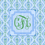 Decorative mahjong mat with a green monogram on a blue and green patterned background