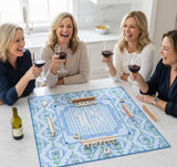 Four women enjoying a game of mahjong with monogram playing mat